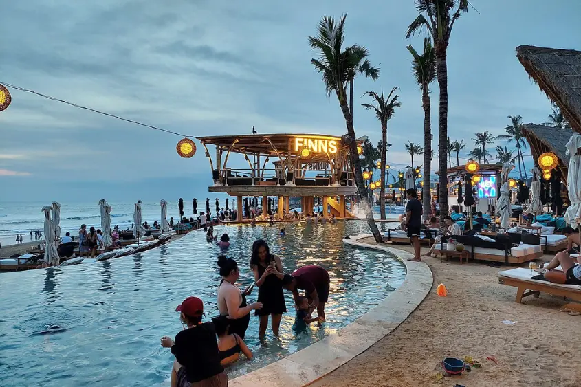 Digital nomad working on laptop at a coworking cafe in Canggu Bali