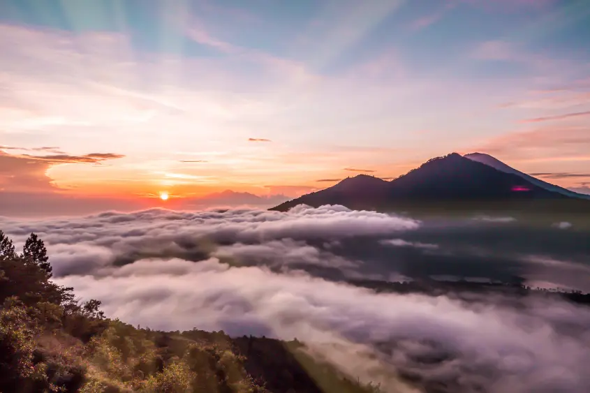 Hikers watching sunrise from Mount Batur volcano in Bali
