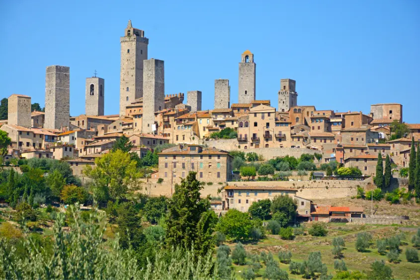 Medieval stone towers of San Gimignano rising above the Tuscan countryside