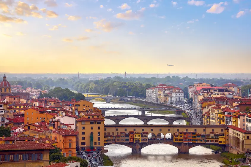 Panoramic view of Tuscany hills with cypress trees and golden valleys at sunset